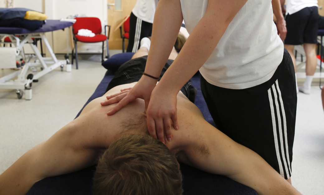 a student recieving a sports massage from another student in a practical 