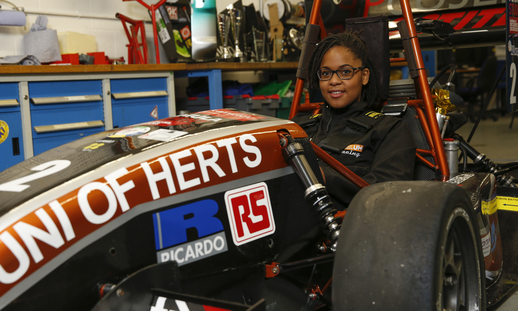 a female student sitting in our single-seater formula student race car