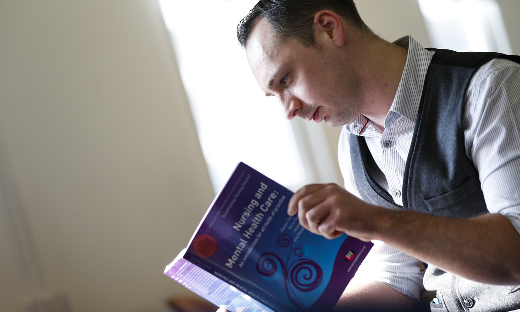 A student reading within a lecture room