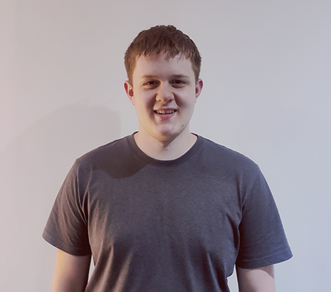 Portrait of a male student in a grey t-shirt