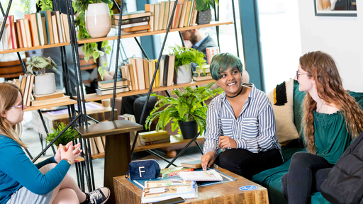 Image of three female students chatting on sofas