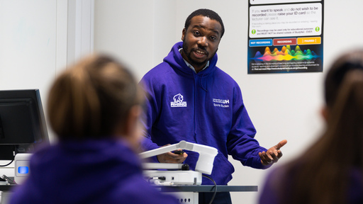 Image of a university lecturer giving a talk to students