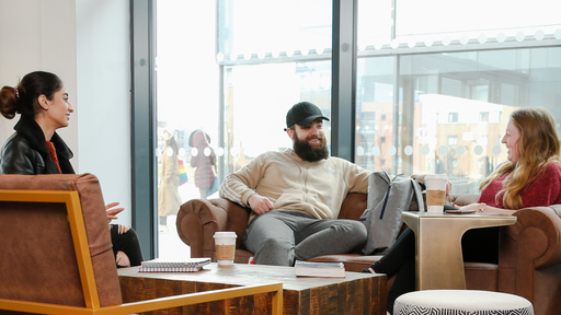 Image of a group of three students chatting 