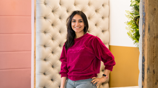 Flare finalist Divya Payel leaning against a table in the enterprise hub