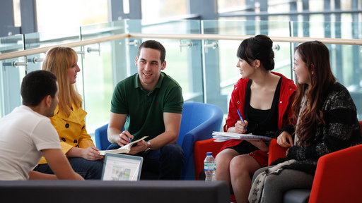 Group of 5 students talking together