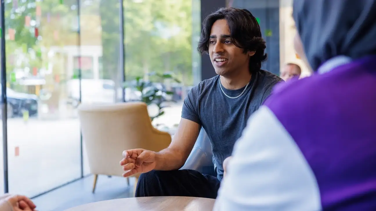 A student sitting down talking