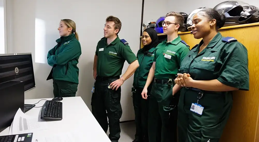 Paramedic students looking at a simulation
