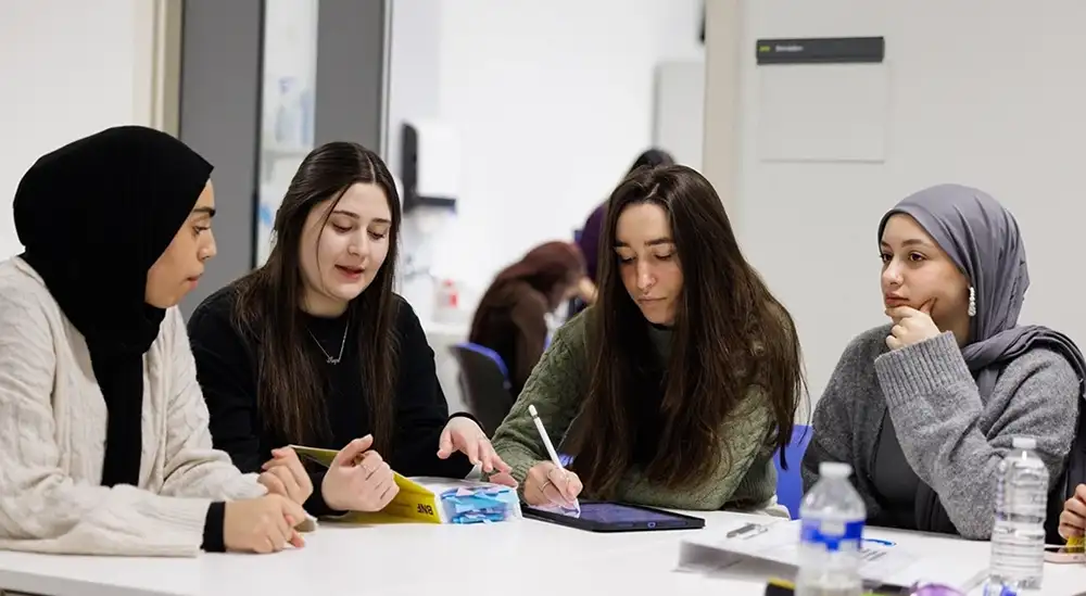 A group of students working round a table