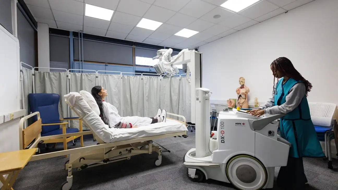 A student practicing with an x-ray machine