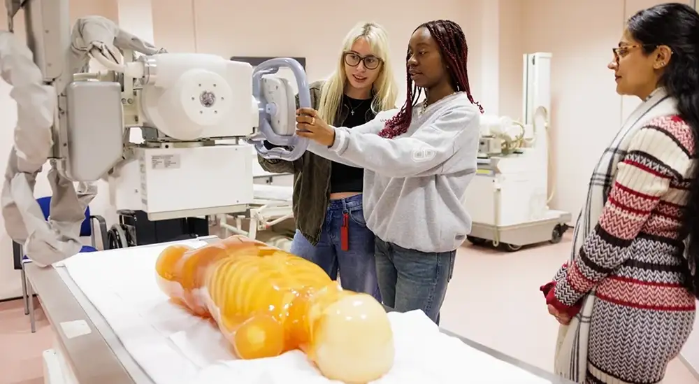 Students practicing using an x-ray machine