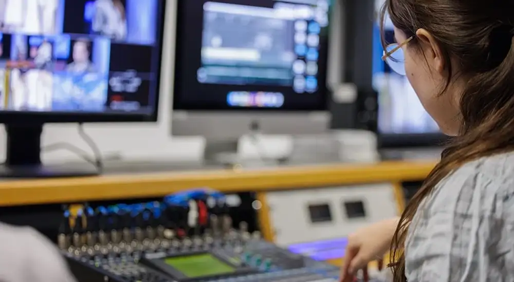 A student looking a recording equipment