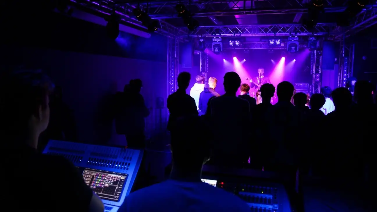 A student using sound equipment as part of a music event