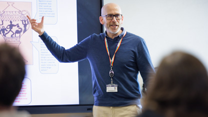 Lecturer talking at the front of the class