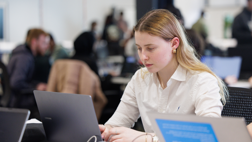 A student typing on a laptop