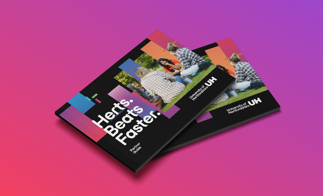 A mock up of the Partner Guide showing a few booklets stacked