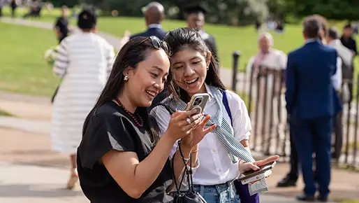 two students looking at a phone