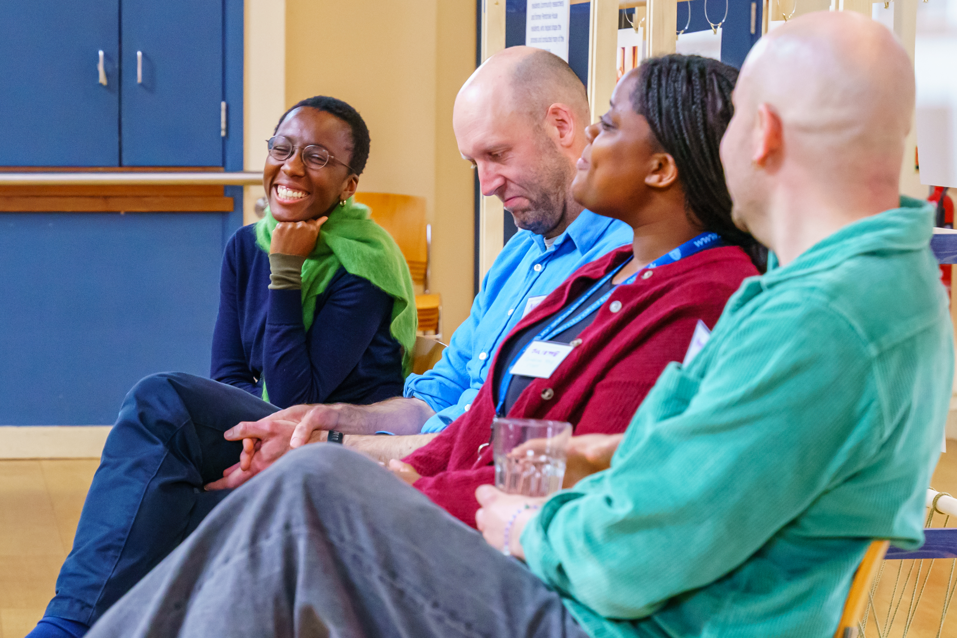 A diverse group of people speak to each other 