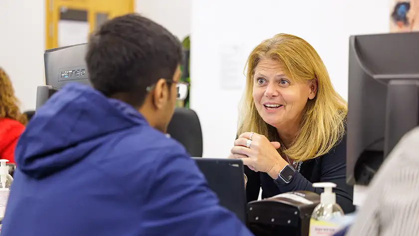 Registrar talking to a student