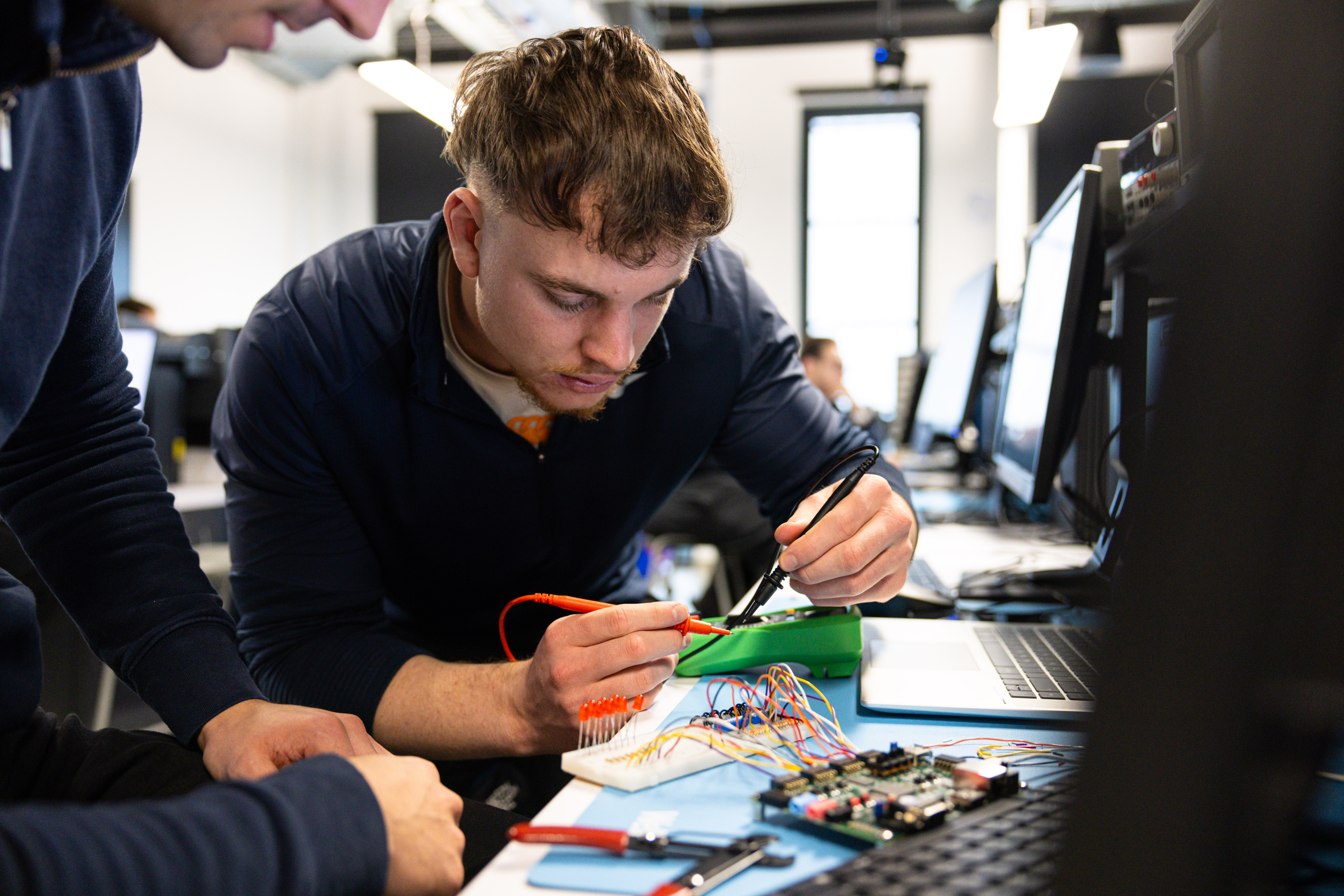 Student using a soldering iron
