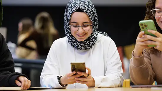 Student looking at the app on her phone