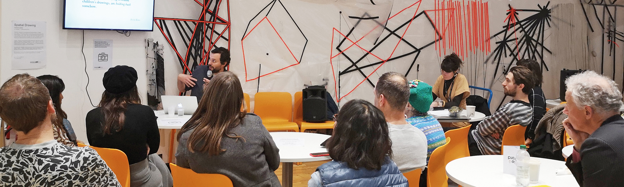 Seated people listening to artist speaker