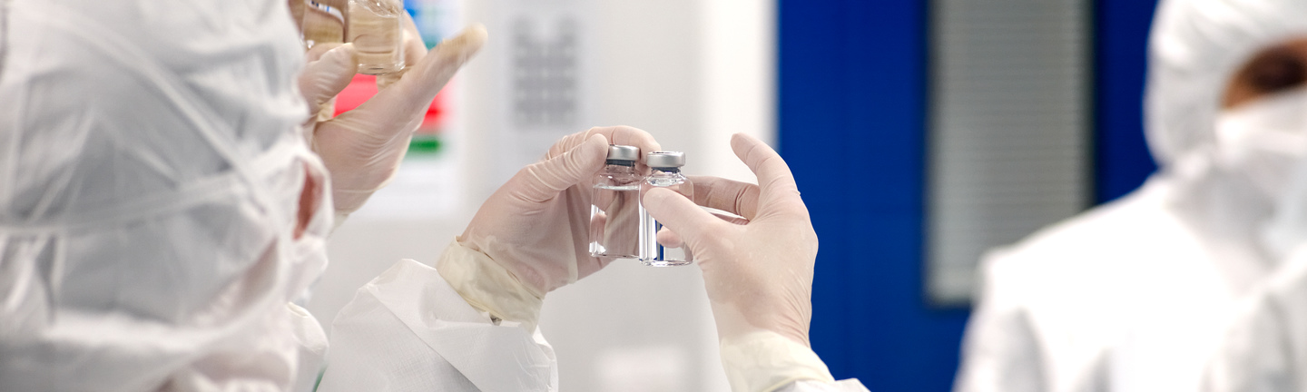 scientists in ppe checking samples