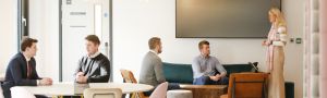 Numerous people having separate meetings at the same time