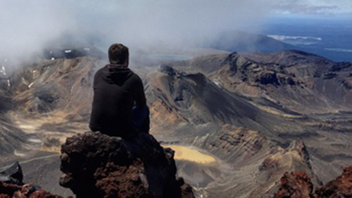 a person looks out over a mountain range