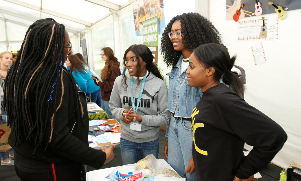 Students talking at a fair booth
