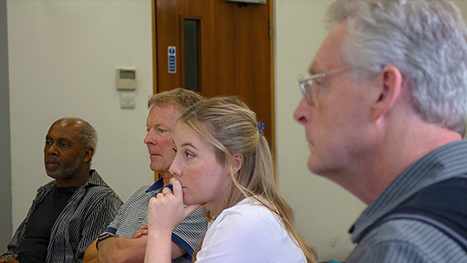 A group of people look focused as the begin work 