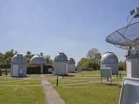 several telescope domes in the summer sun