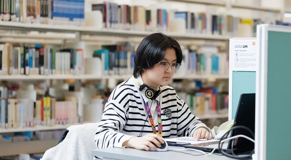 A student working at a laptop