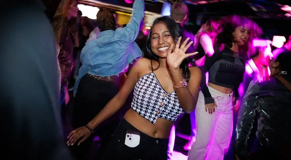 A student posing for a picture in the University nightclub