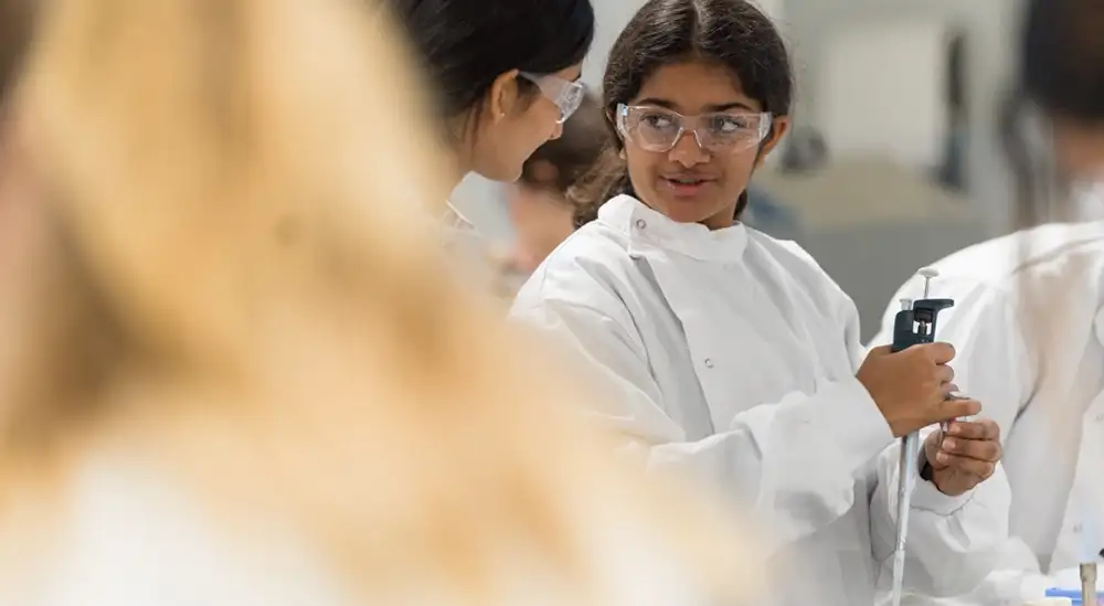 A group of students in a lab working with a pipet