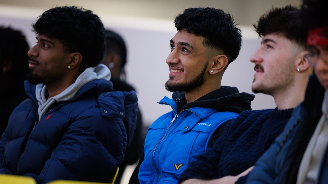 A group of students smiling while sitting down