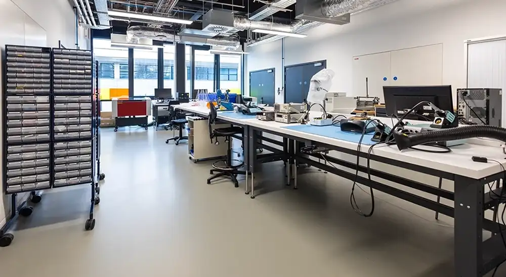 A room with soldering equipment on tables