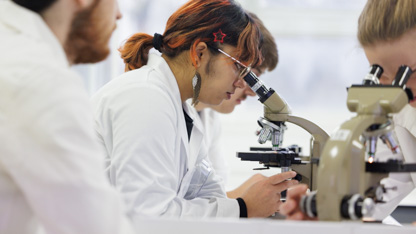 Student looking through a microscope