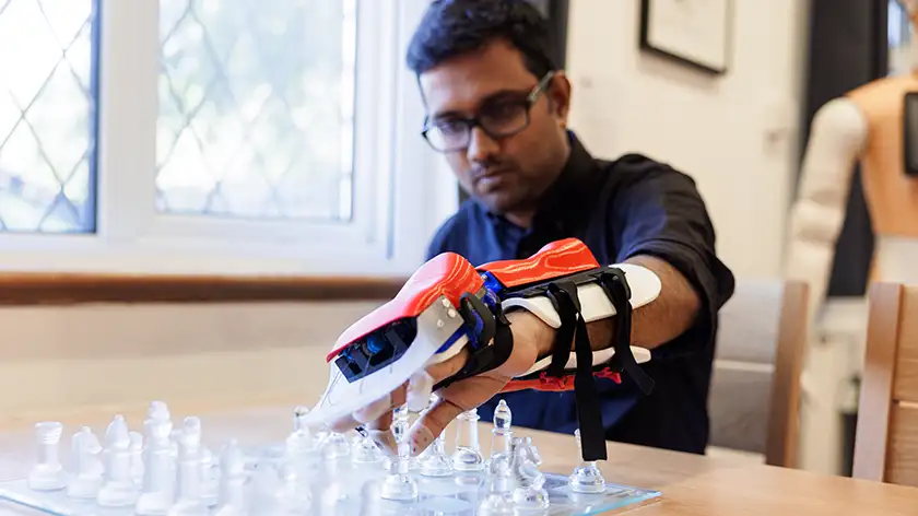 A person with a robotic device attached to their hand