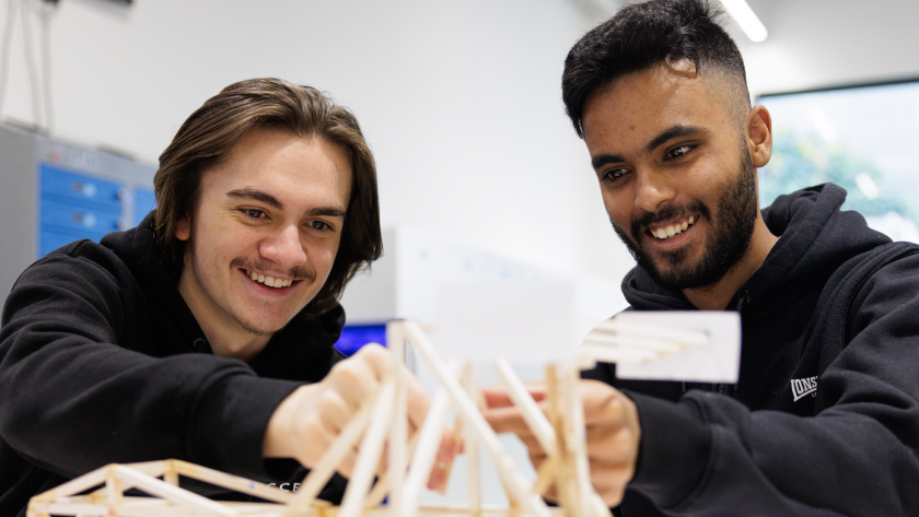 Two students working with electric models