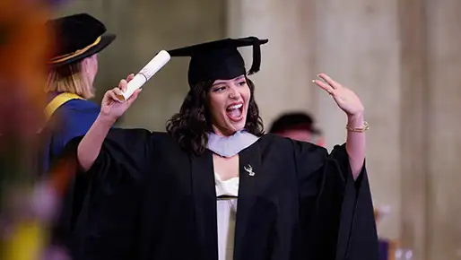 student at graduation with robe and hat on