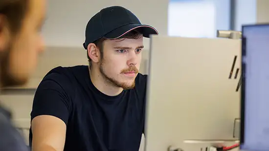 Student sitting working in front of a desktop