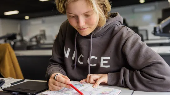 A student working witha pencil in hand