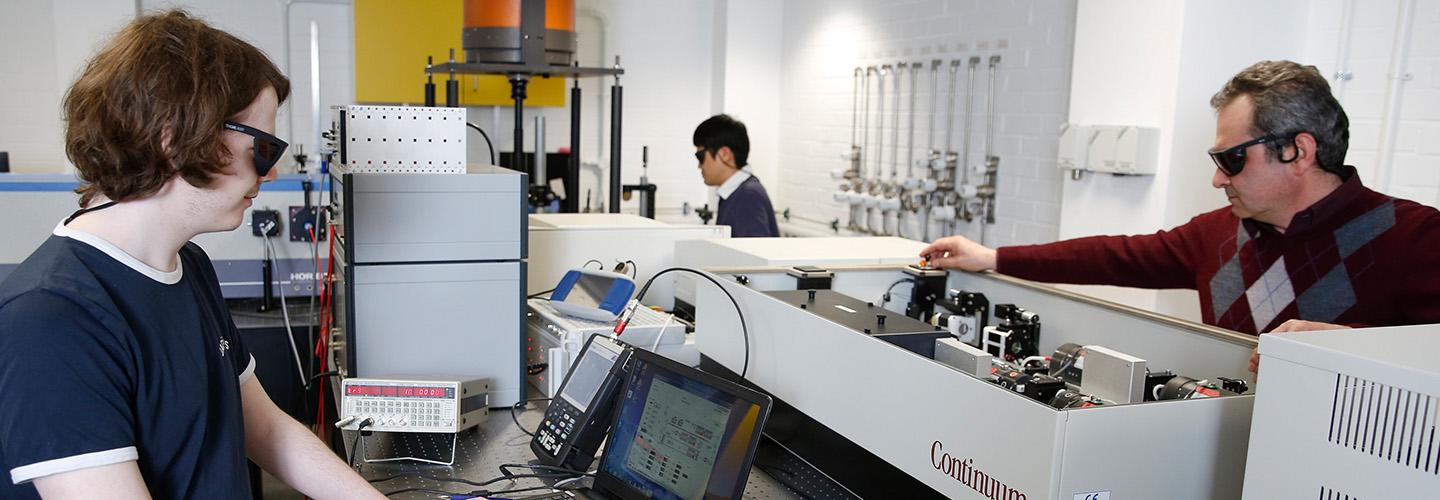 Students and staff working in a physics lab