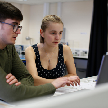 Two students on laptop