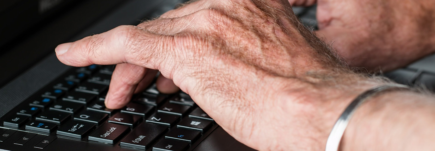 Hands of elderly computer user