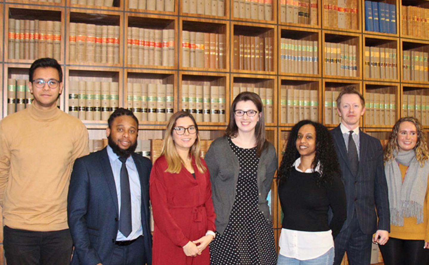 Law students in front of bookshelf