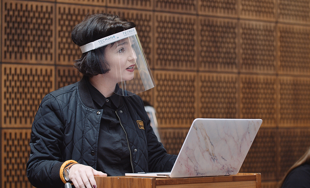 A law student wearing a face shield, takes part in a mock trial in our law court