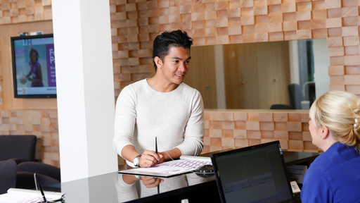 Student at College Lane reception, smiling