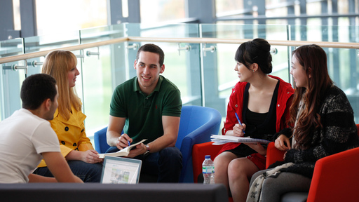 Group of 5 students talking together