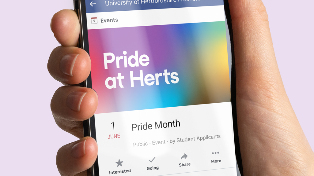 An iPhone displaying a social media post from the University of Hertfordshire, talking about Pride month activities